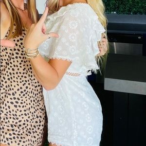 Floral white romper. White ruffle sleeve. Lace up open back.